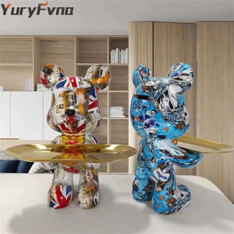 Two stylized bear figurines decorbites graffiti bear with British flag and floral patterns holding polished gold key trays