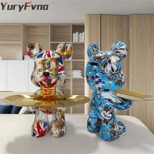 Two stylized bear figurines decorbites graffiti bear with British flag and floral patterns holding polished gold key trays