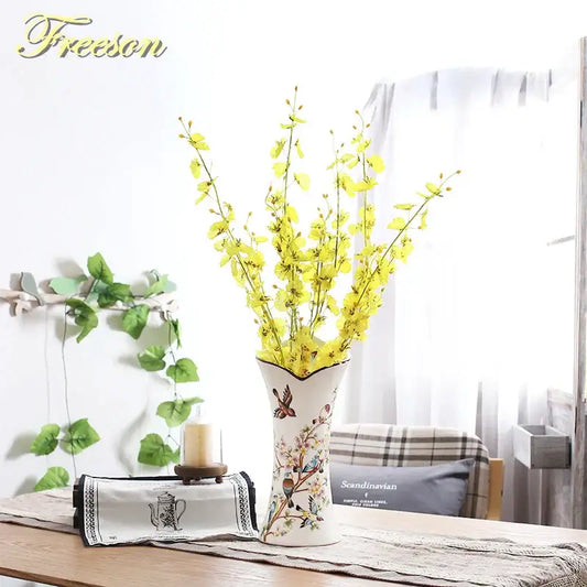 White ceramic bird butterfly porcelain vase with hand-painted floral design holding yellow artificial flowers for decorbites decor