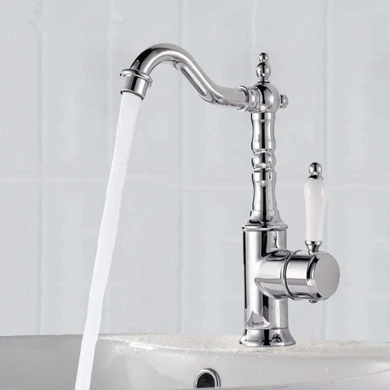 Chrome finished bronze basin faucet with curved spout and off-white ceramic handle for cold water use