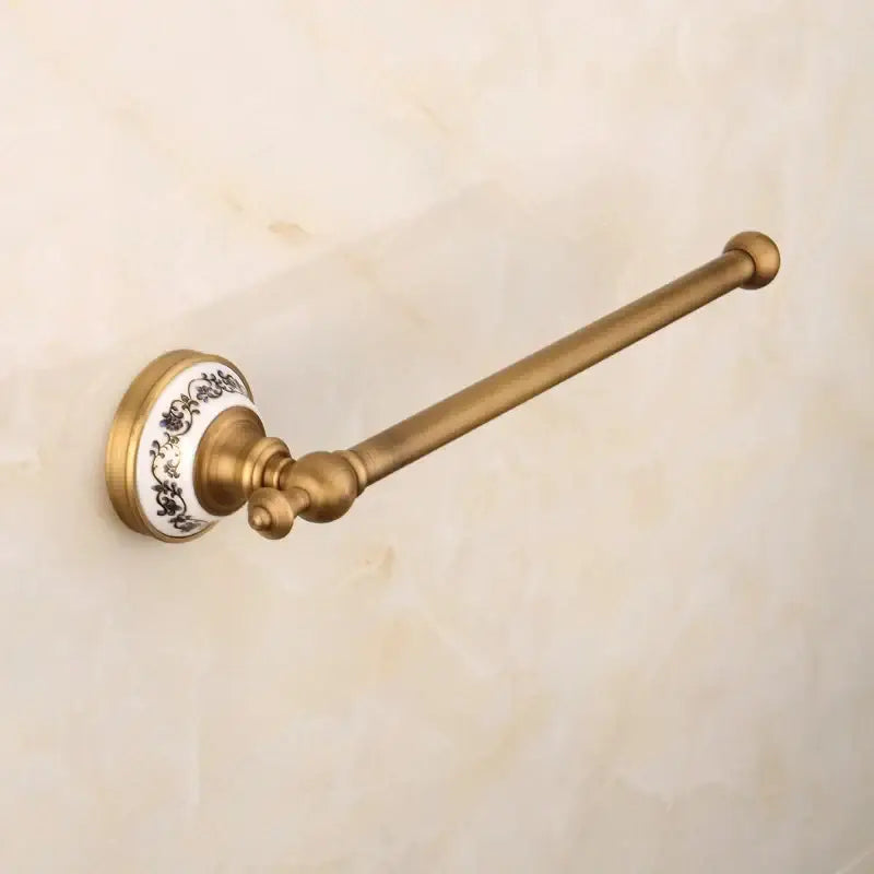 Antique brass towel rack with white ceramic base and black floral patterns from decorbites bronze bathroom hardware set