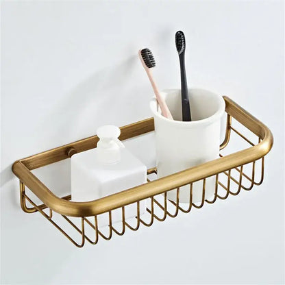 Bronze bathroom hardware set with gold-toned metal caddy woven design holding ceramic cup and frosted soap dispenser