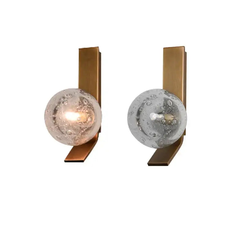 Pair of bronze wall sconce lamps with brass finish and translucent bubble glass spheres for bedroom use