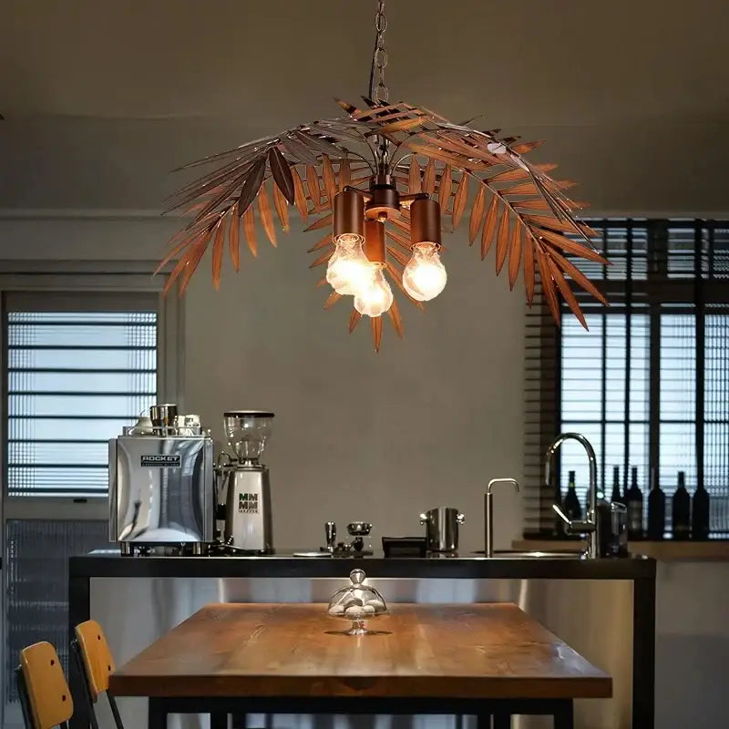 Bronze coconut tree pendant lamp with bronze-colored metal leaf design and three exposed bulbs for dining room decorbites bronze coconut