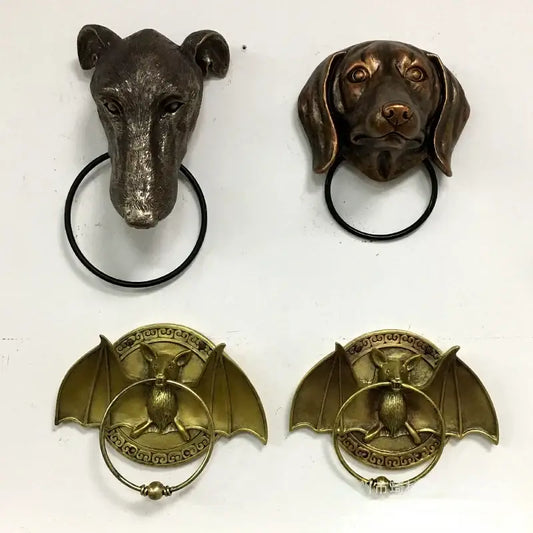 Bronze dog head door and bat door knocker pendant with black rings for courtyard wall installation