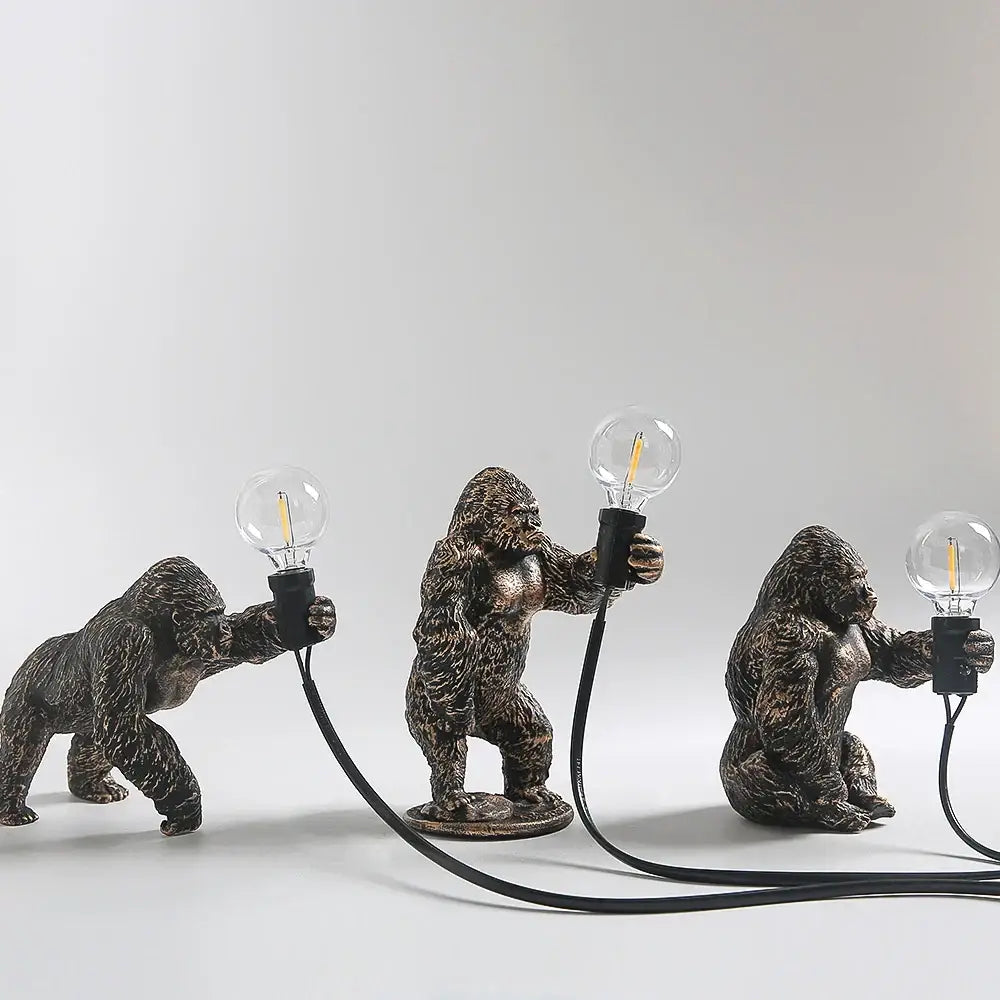 Bronze king kong gorilla table lamp featuring three bronze-finished gorillas holding edison filament bulbs by decorbites