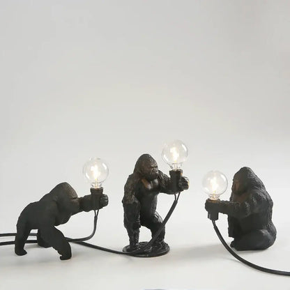 Three black bronze king kong gorilla table lamps holding glowing bulbs ideal for bedroom night light decorbites king kong