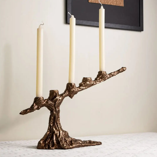 Bronze tree branch bamboo candle holder with three cream candles featuring intricate textured decorbites bamboo candle decor