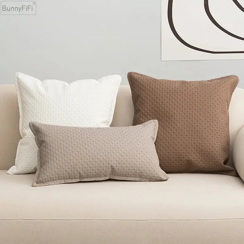 Three textured brown beige faux leather cushion covers 45x45cm on a light sofa for decorbites living room decor