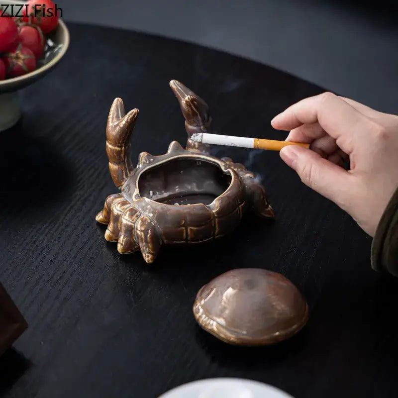 Bronze-colored decorbites crab ceramic ashtray with detailed claws and shell texture serves as phone holder and desk decoration