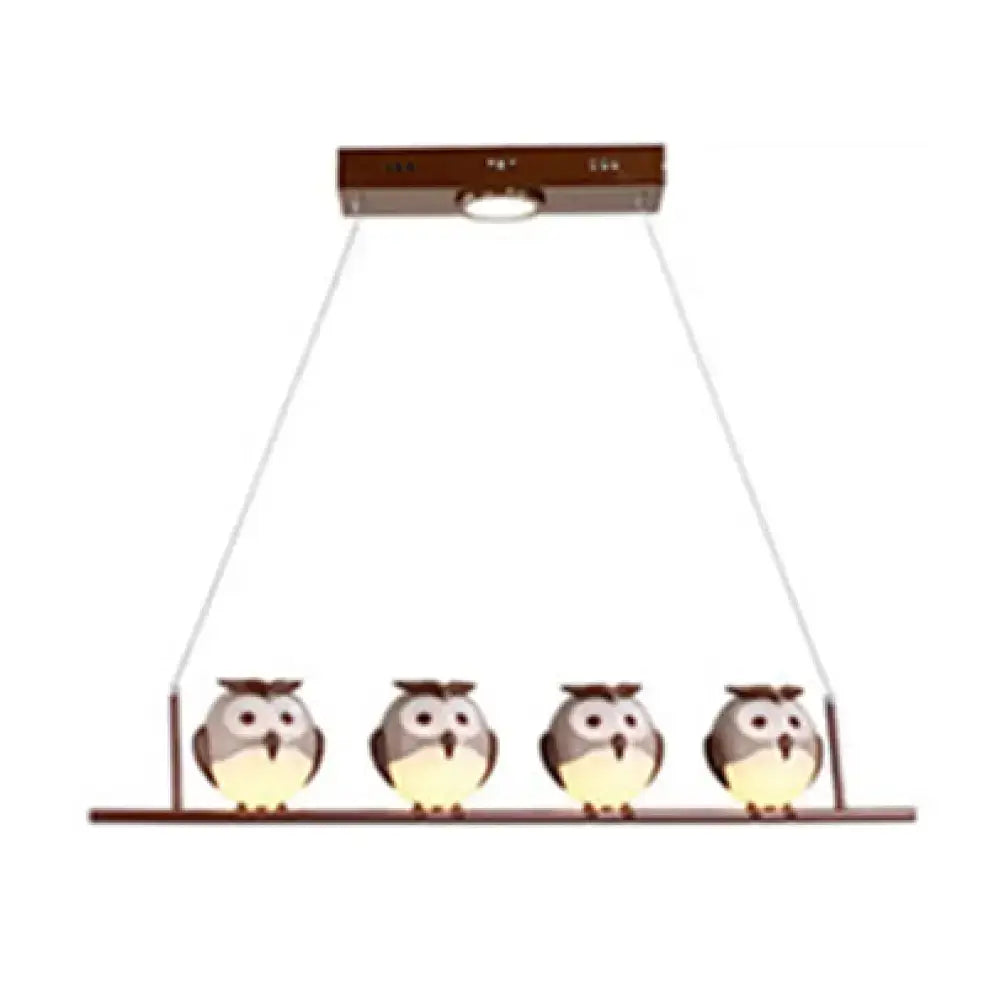 DecorBites owl metal pendant light with four gray and white owls and yellow led incandescent underbelly lighting