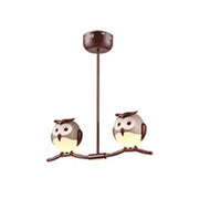 Brown metal pendant light featuring two cartoon owls with glowing yellow underbellies using led incandescent bulbs