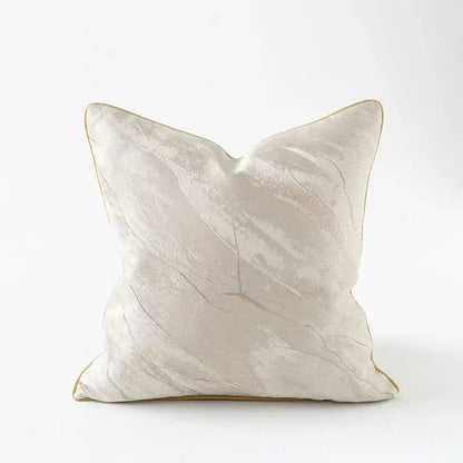 Cream-colored pillow cover with subtle marble texture and gold piping featuring auspicious clouds jacquard design
