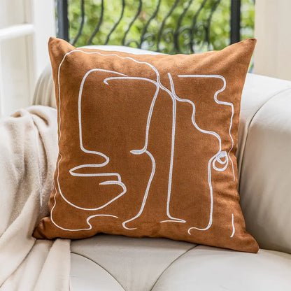 Brown suede cushion cover with white decorbites geometric embroidery of abstract faces for living room decor