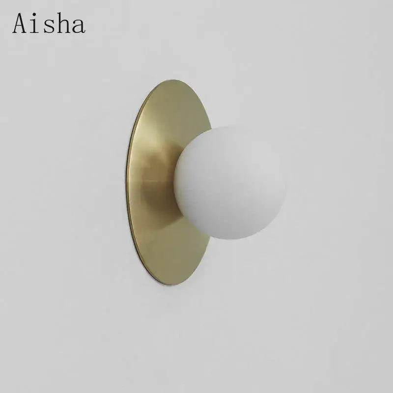 Aisha brand brushed brass circular wall lamp with a matte white frosted glass shade for bedroom decorbites circular wall decor