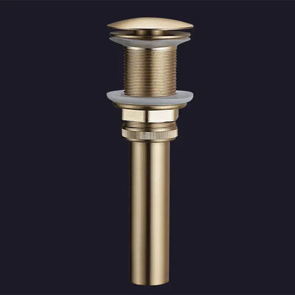 Brushed gold and white ceramic bathroom sink drain assembly kit with gold-toned brass cylindrical body and threaded sections
