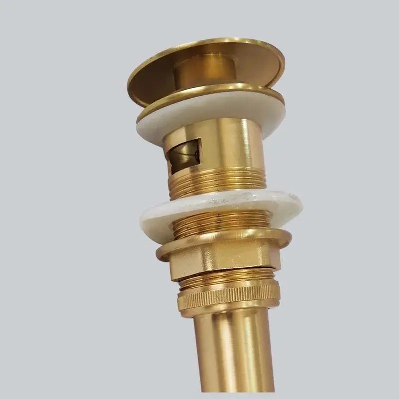 Brushed gold basin sink drain with overflow featuring gold-toned brass and white ceramic washers for decorbites brushed gold decor