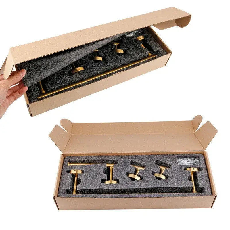 Brushed gold bathroom hardware set with towel bar and robe hooks neatly packaged in cardboard box with black foam