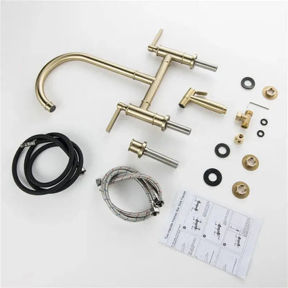 Brushed gold kitchen bridge faucet with hand shower head and brass-finished two-handle kit including flexible hoses