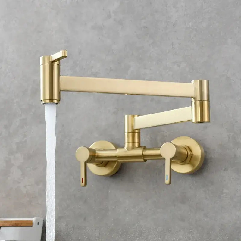 Brushed gold kitchen faucet with foldable spout and dual handles featuring a sleek extendable modern design