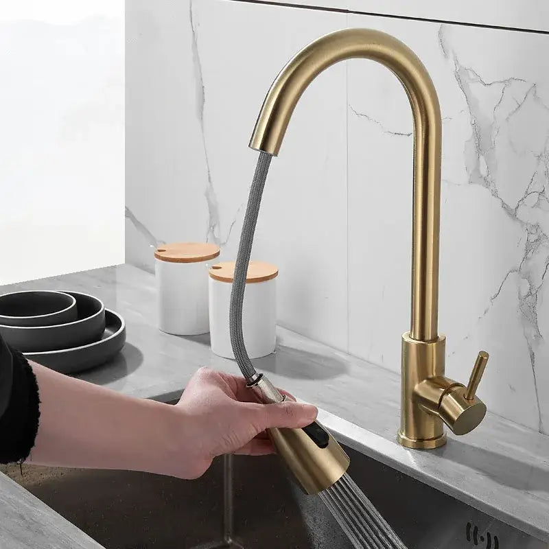 Brushed gold kitchen faucet with pull down spray head, brass finish, flexible hose, and sleek curved spout by decorbites