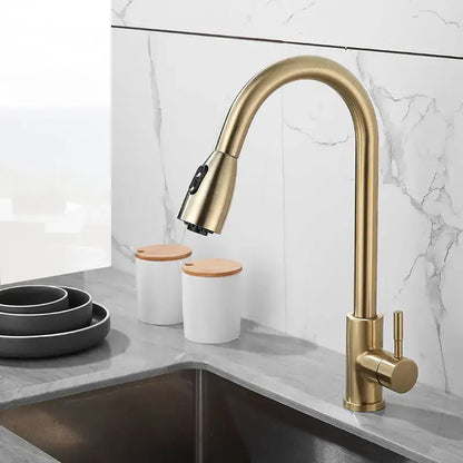 Brushed gold kitchen faucet with pull down spray head and sleek curved spout by decorbites for modern kitchens