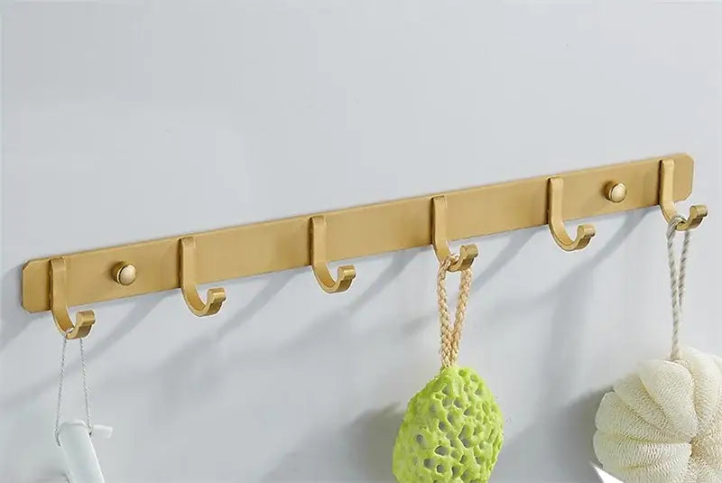 Brushed gold metal wall-mounted robe hooks with five decorative round knobs from decorbites brushed gold collection