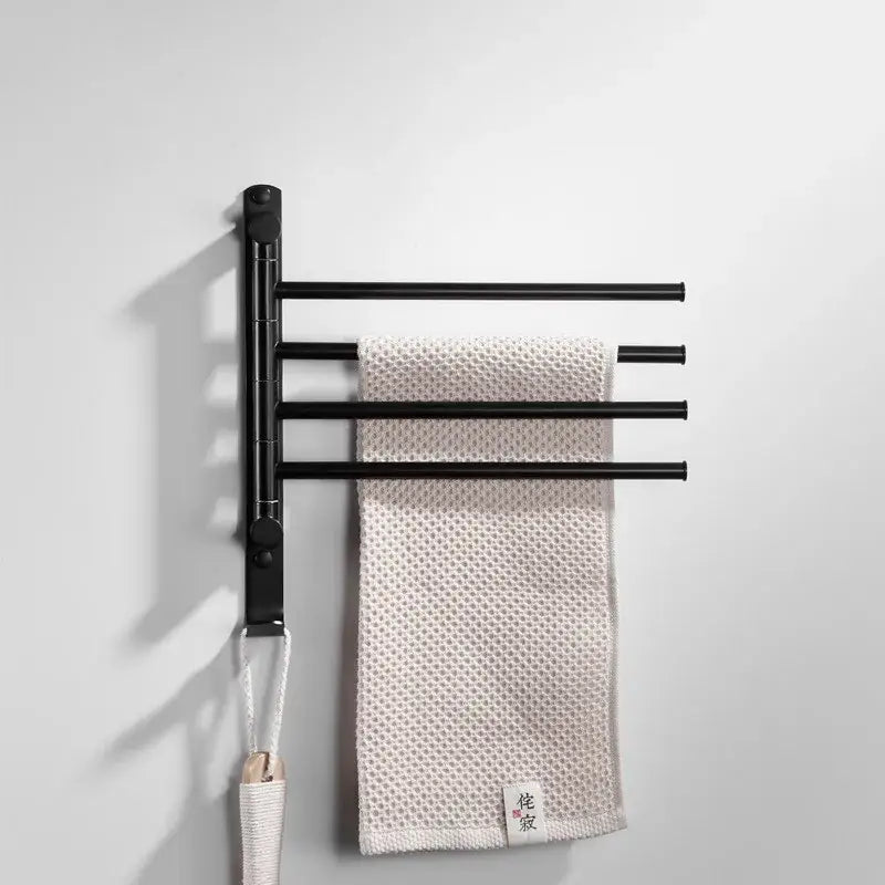 Black metal wall-mounted towel hanger with four extendable bars holding beige towel for decorbites brushed gold rack