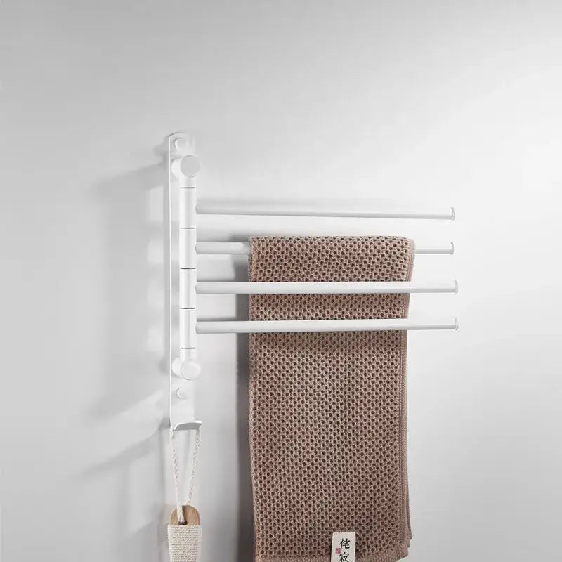 White wall-mounted towel hanger with four bars holding a beige towel for decorbites brushed gold swivel rack bathroom use