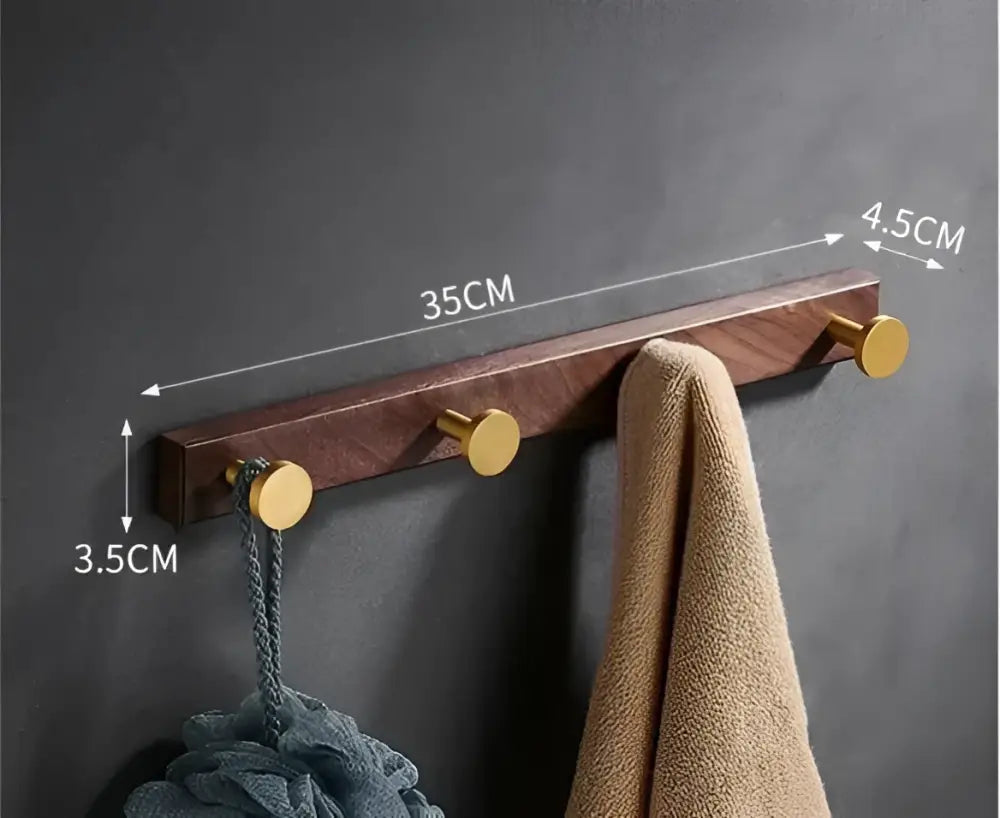 Brushed gold wood and aluminum robe hook towel hanger with three gold-toned circular hooks for bathroom use