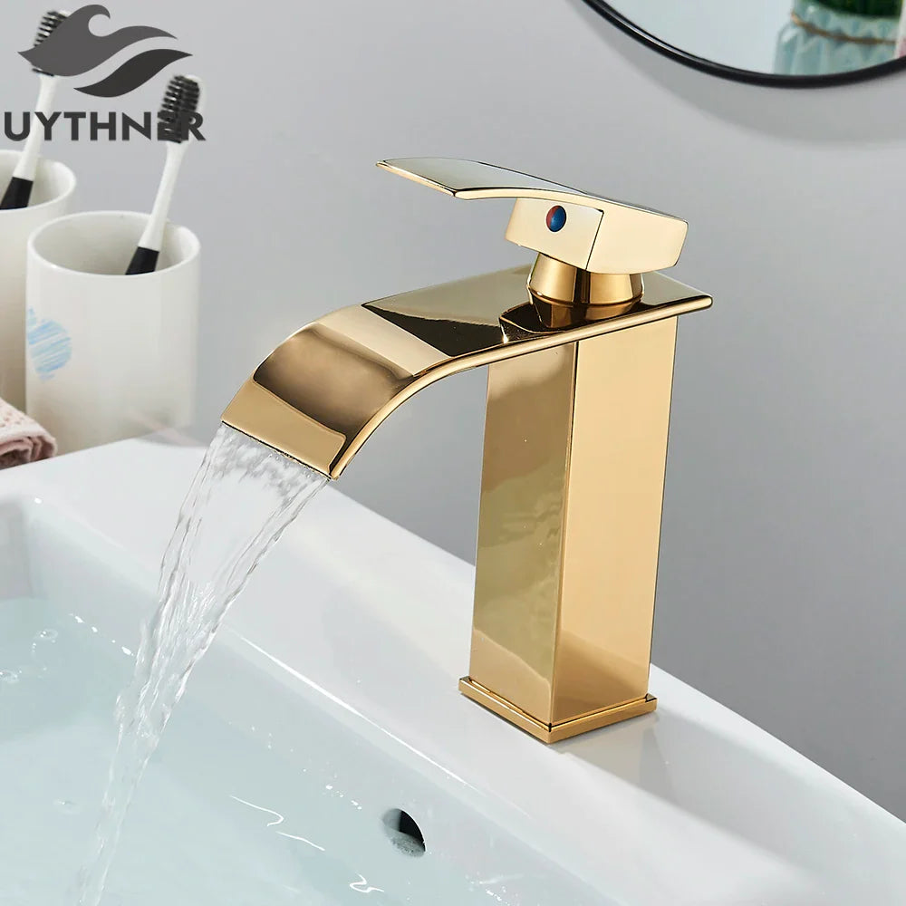 Brushed golden single hole basin faucet with waterfall design and blue accent lever for elegant bathroom sinks