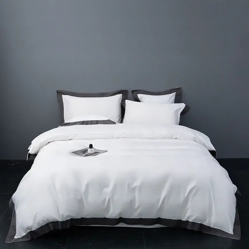 White satin duvet cover with dark gray piping and matching pillowcases in decorbites brushed hotel style bedding sets