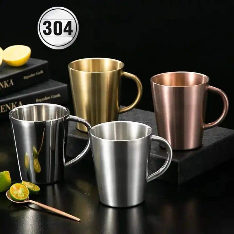 Set of four brushed metallic stainless steel thermal mugs in silver gold and rose gold for kitchen drinkware