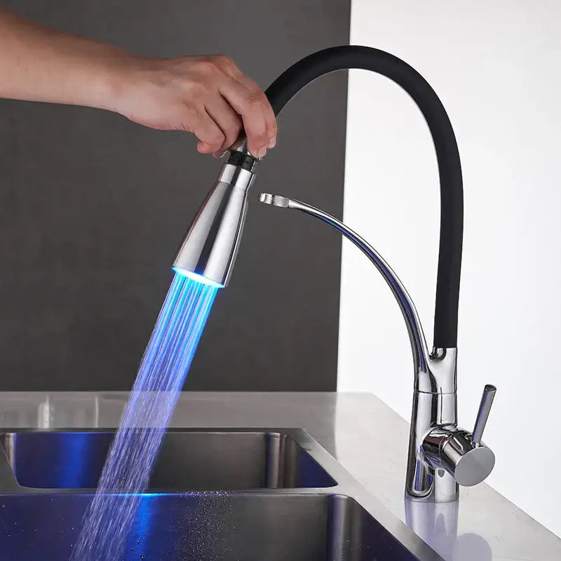 Chrome finished kitchen sink faucet with black flexible hose and illuminated blue spray head for pull down use