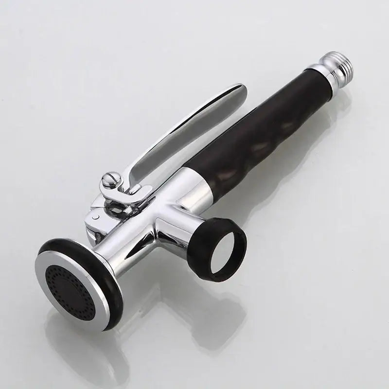 Chrome kitchen shower head with black rubber grip and circular spray head designed for handheld use