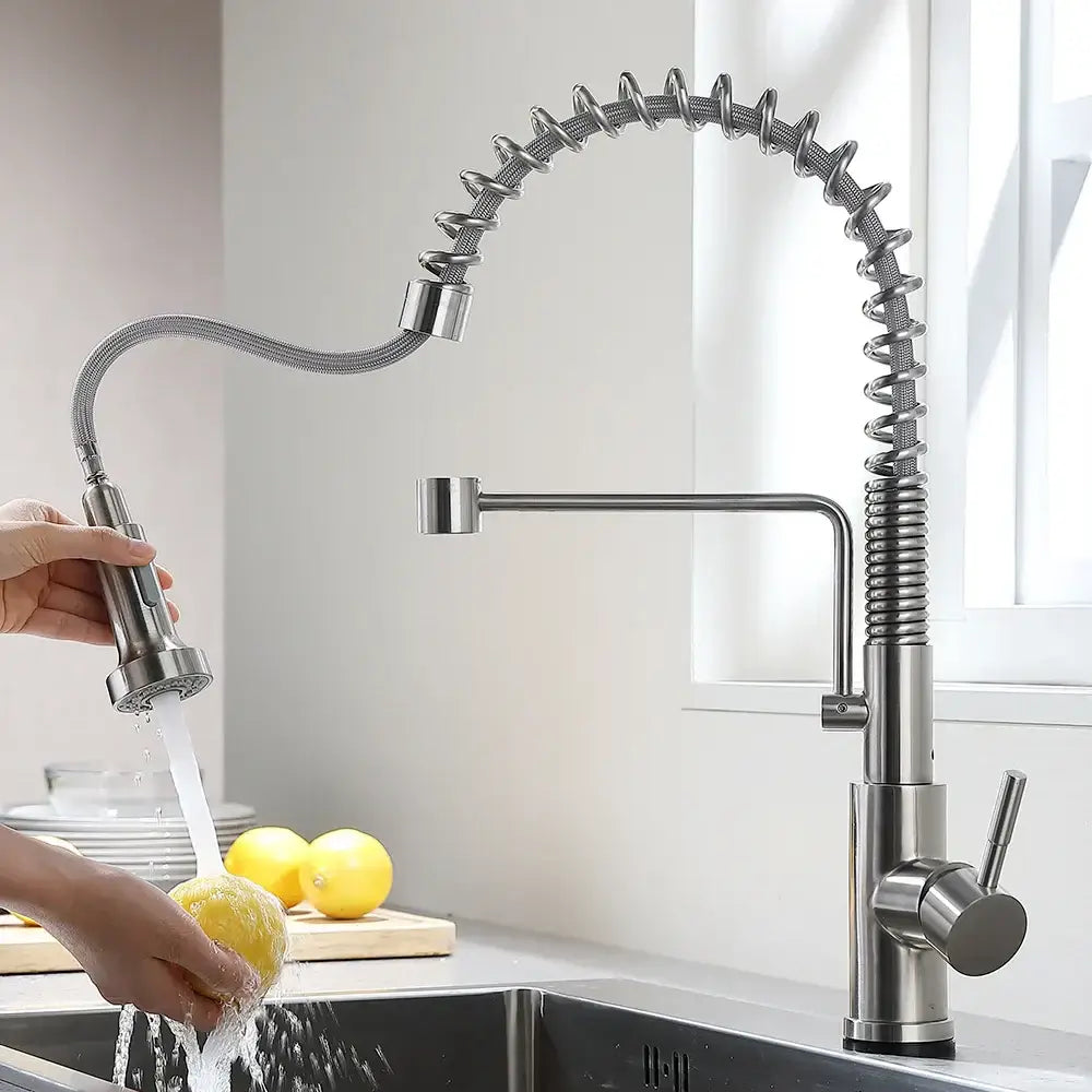 Brushed nickel sensor kitchen faucet with flexible coiled hose and pull down spray head in stainless steel