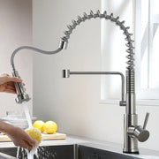 Brushed nickel sensor kitchen faucet with flexible coiled hose and pull down spray head in stainless steel