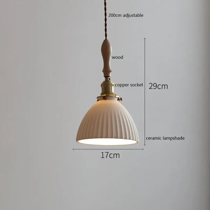 A cream-colored butterfly ceramic led pendant lamp with vertical ridges, wooden handle, and brass copper socket for decorbites