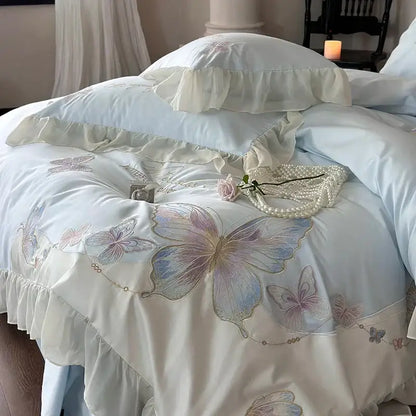 Light blue cotton bedding set with decorbites butterfly embroidery and lace ruffles featuring satin duvet cover