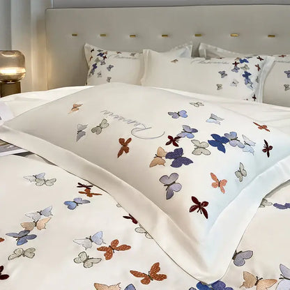 White satin pillowcase with decorbites butterfly embroidery in blue purple orange and gray on cotton bedding set