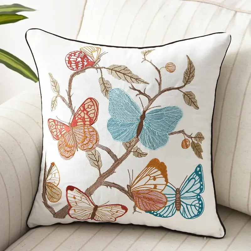 White embroidered butterfly floral cotton pillow cover with blue orange and red butterflies and black piping decorbites butterfly floral decor