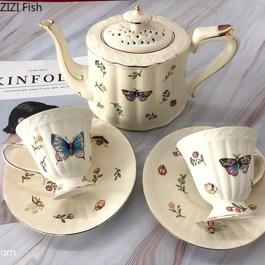 Cream-colored butterfly gold ceramic teapot set with gold trim and hand-painted butterfly gold floral designs