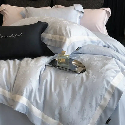 Light blue satin duvet cover with white butterfly jacquard embroidery and cream piping in decorbites butterfly jacquard bedding set