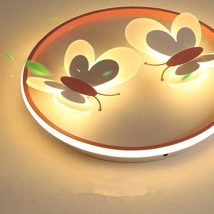 Butterfly pink ceiling light with illuminated butterfly designs in warm yellow glow and white maroon rim for kids room decorbites butterfly pink