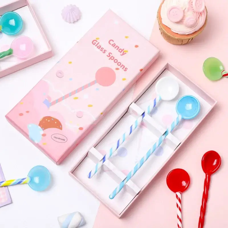 Pastel pink gift box with candy colorful glass stirring spoons featuring striped handles and glossy lollipop bowls for decorbites colorful glass decor