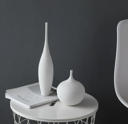 White ceramic capiron zen vases with sleek minimalist design on white side table for nordic home decoration centerpiece