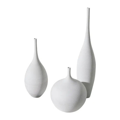 Set of three white ceramic vases with textured surfaces and slender necks for nordic home decoration by capiron