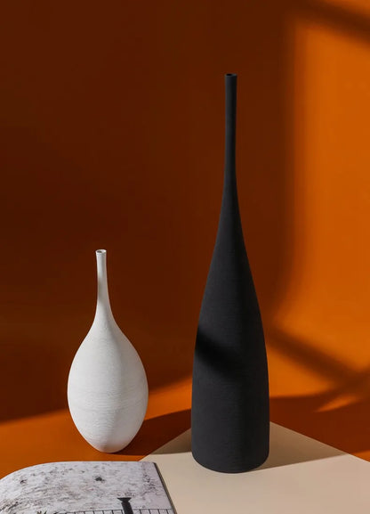 Black matte ceramic zen vase with slender neck and tapered base for nordic living room decoration and centerpiece