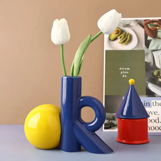 Blue abstract ceramic vase shaped like letter k holding white tulips for decorbites cartoon abstract living room decor