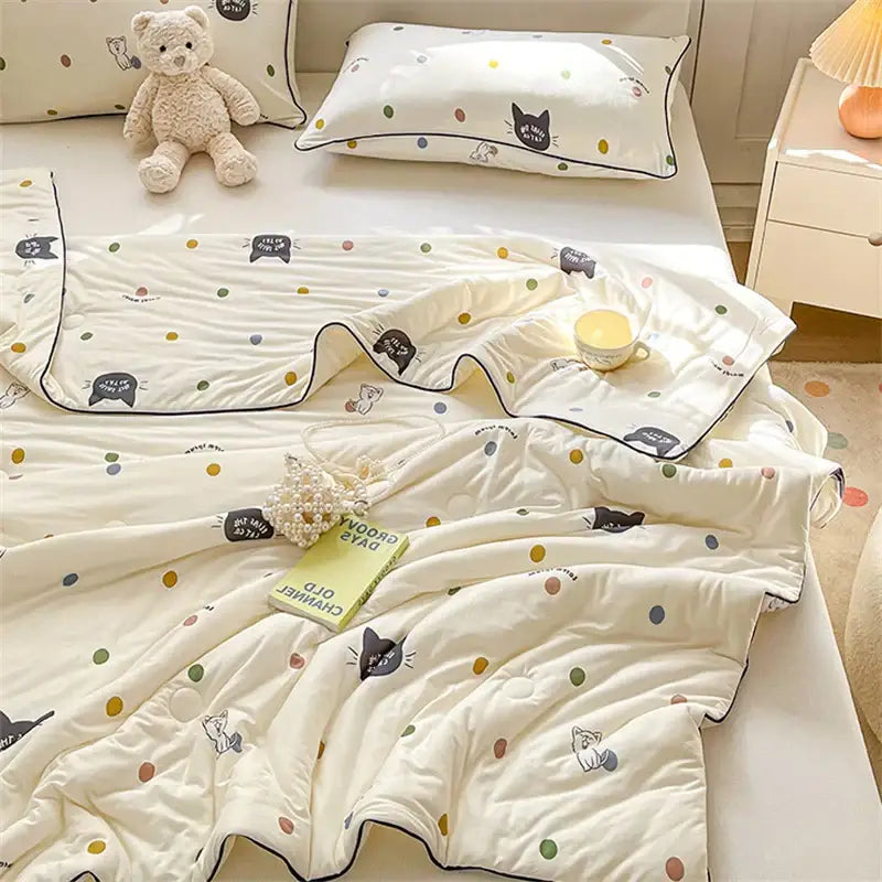 Cream-colored quilted kids summer quilt with black cat and polka dots featuring soft cotton texture by decorbites kids